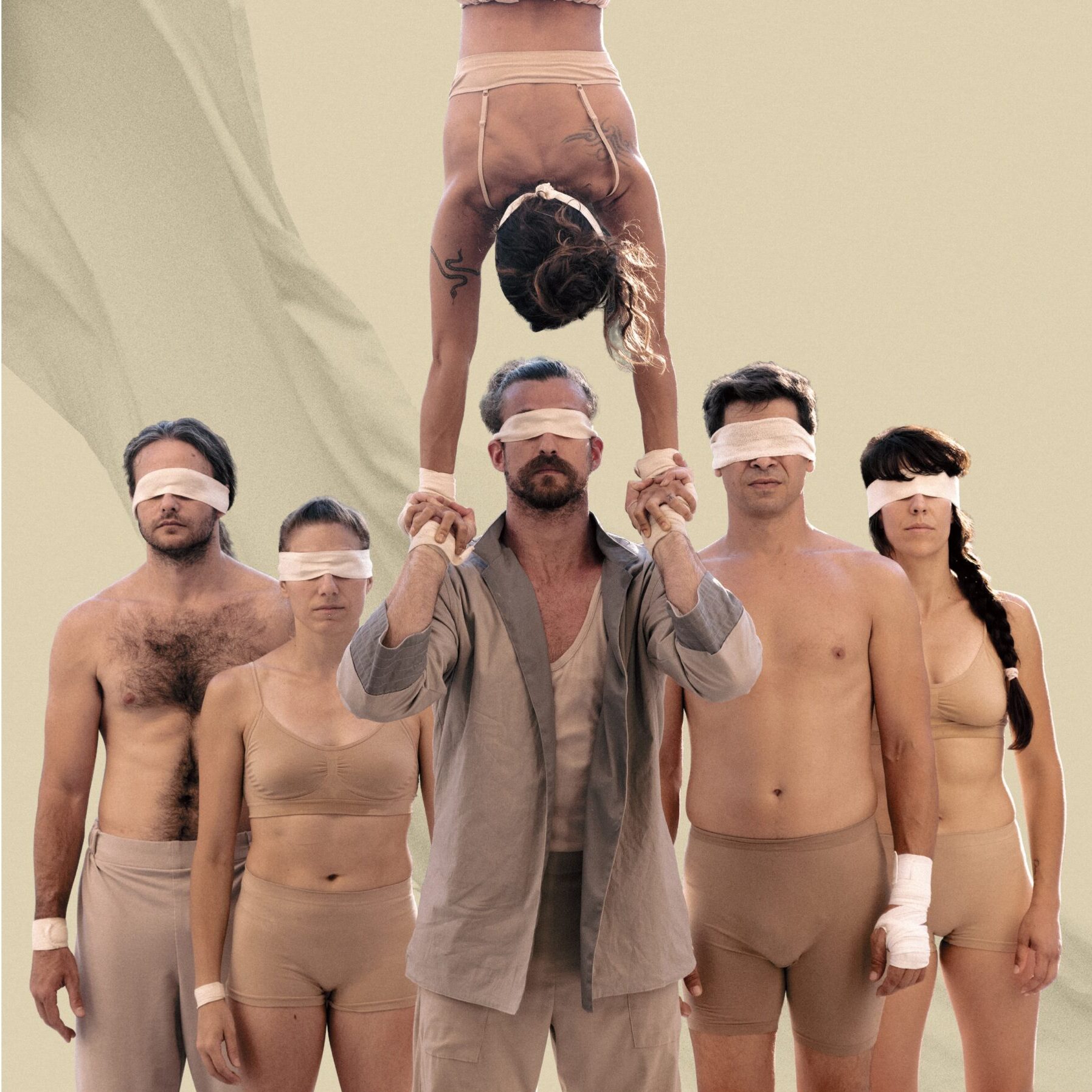 Artistas de circo con los ojos vendados y acrobacia.